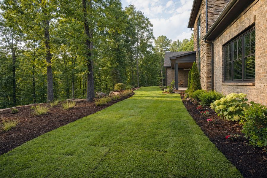 Freshly installed sod and mulched landscape beds